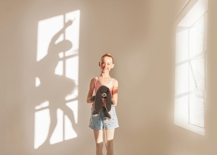 Ballet, motivation and children with a girl thinking of dance and holding a teddy bear in a dancing